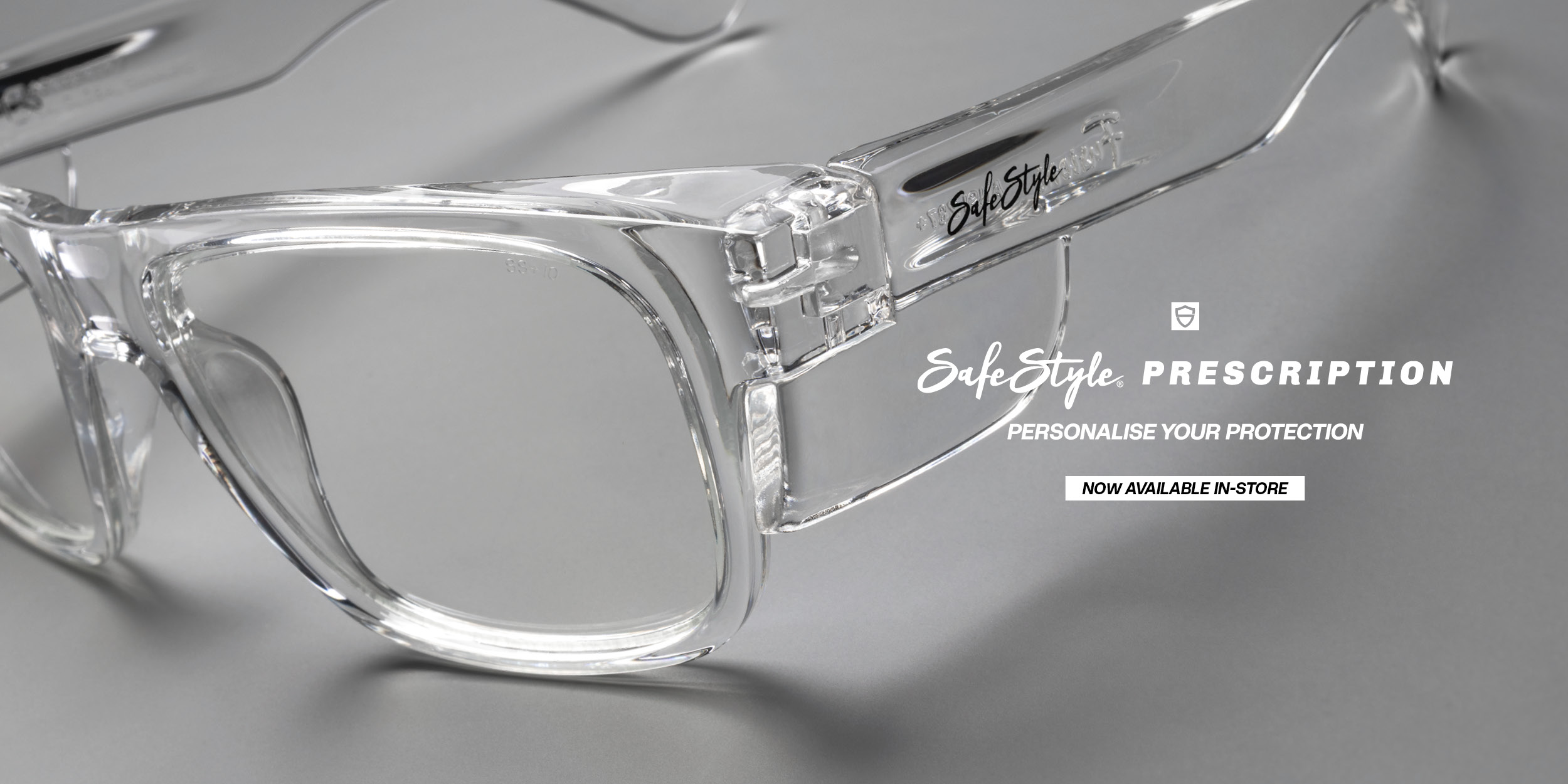 Close-up of a clear SafeStyle prescription safety frame with side shield and SafeStyle Prescription branding