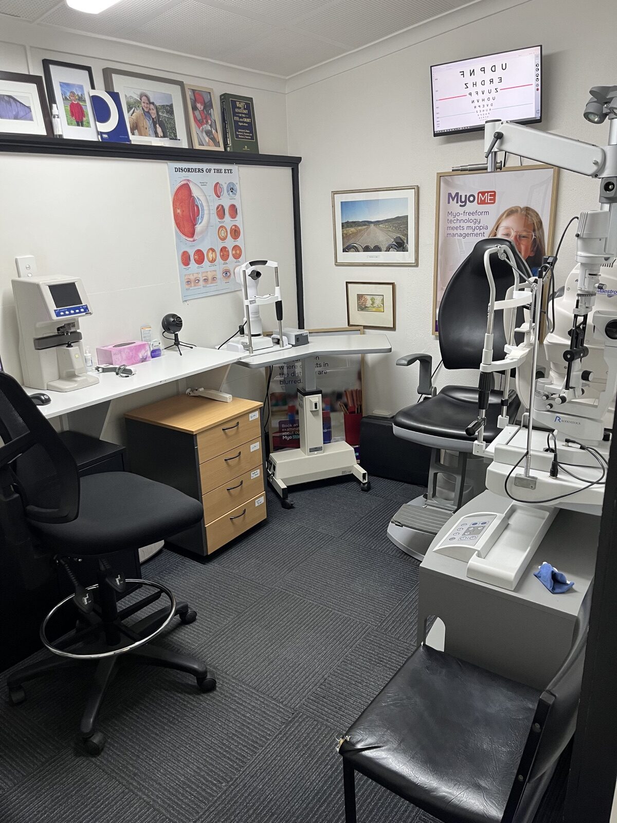 Consulting room at Reservoir Spectacles, with an examination chair, eye-test chart and examination equipment
